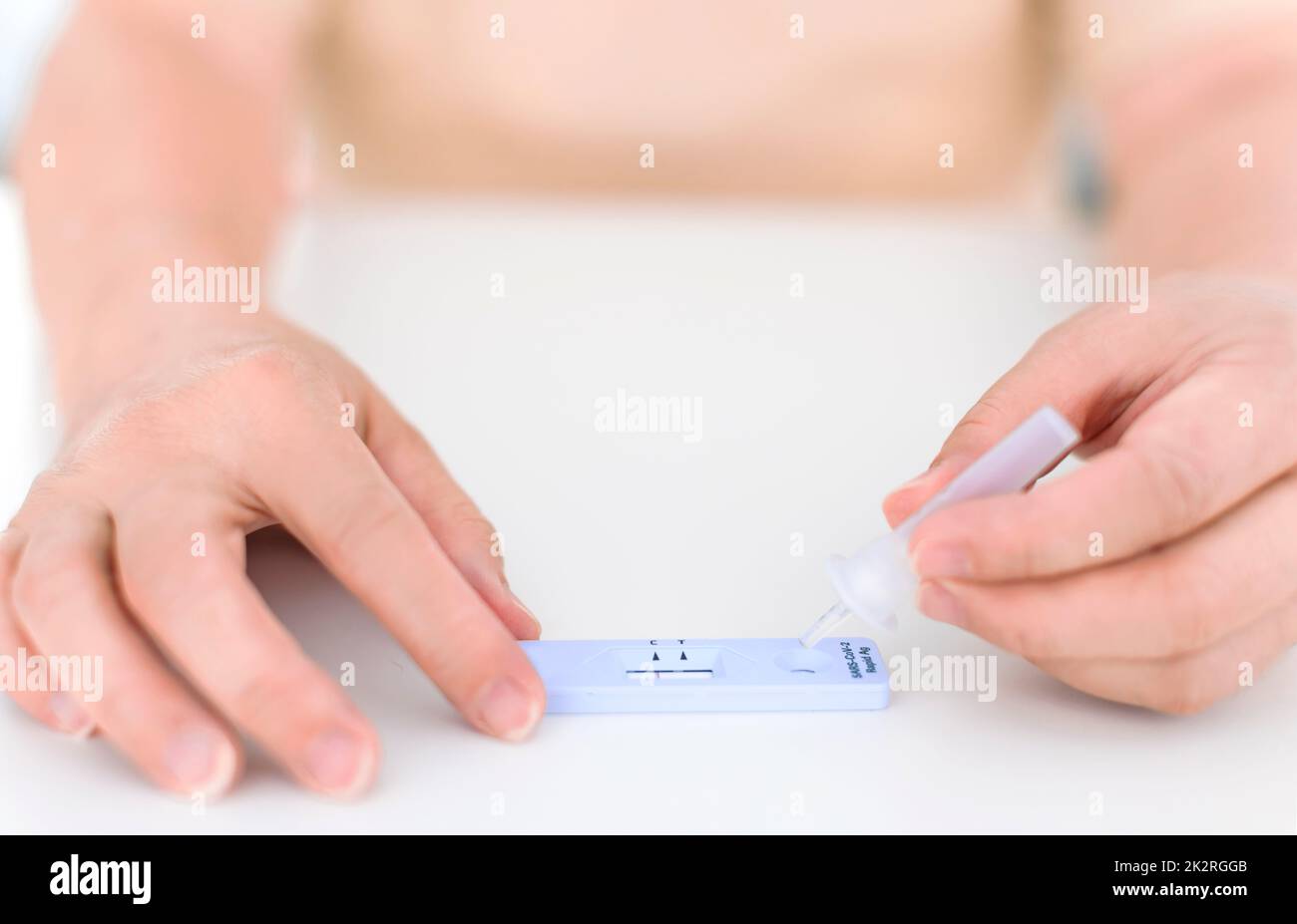 Woman using coronavirus covid-19 rapid antigen home testing kit Stock Photo