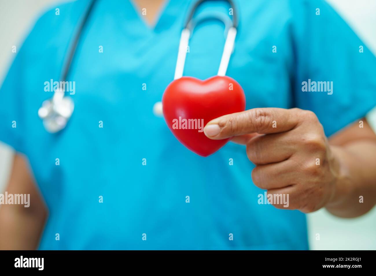 Asian woman doctor holding red heart for health in hospital Stock Photo ...
