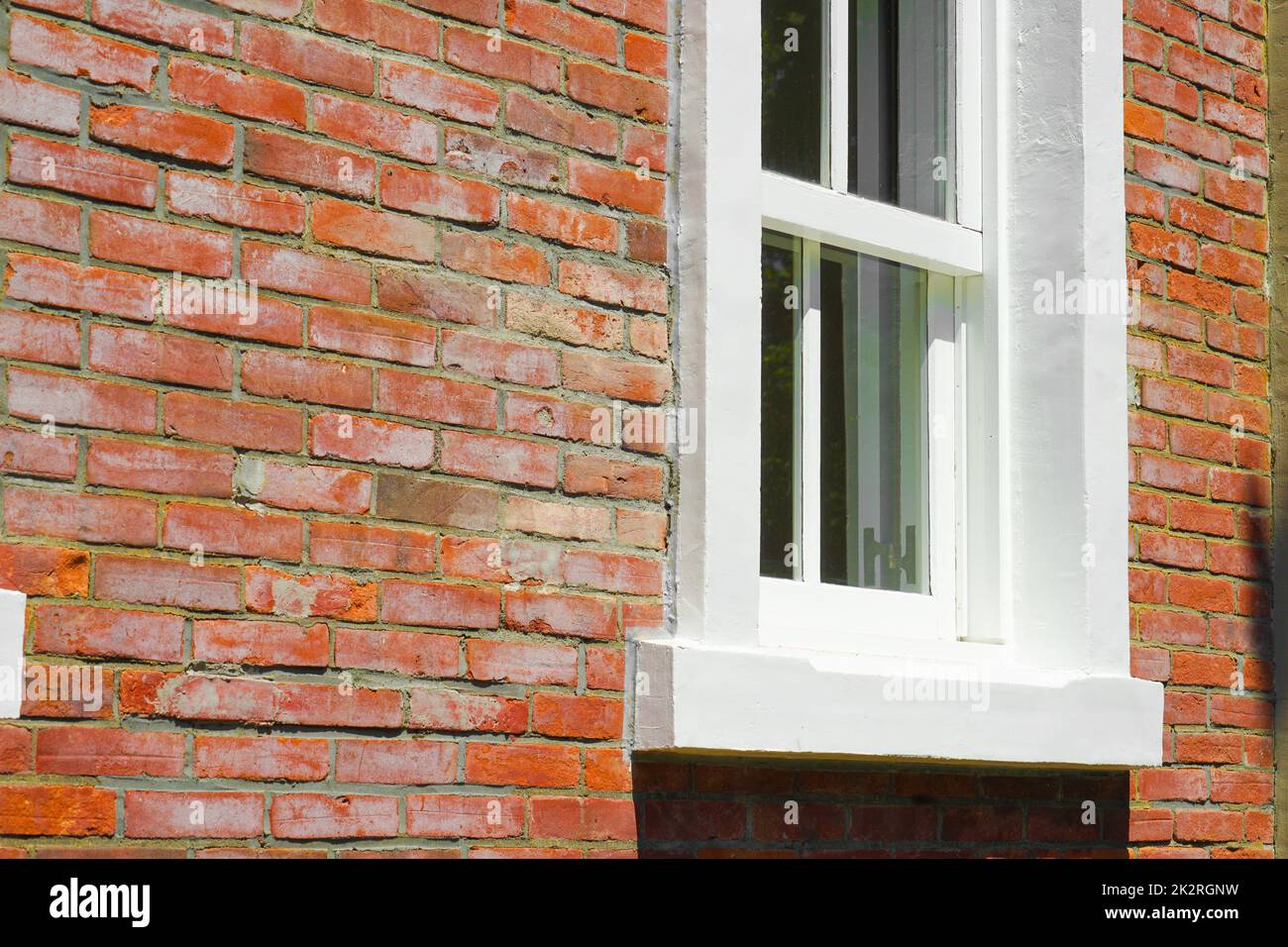 Brick outer wall and white window Stock Photo