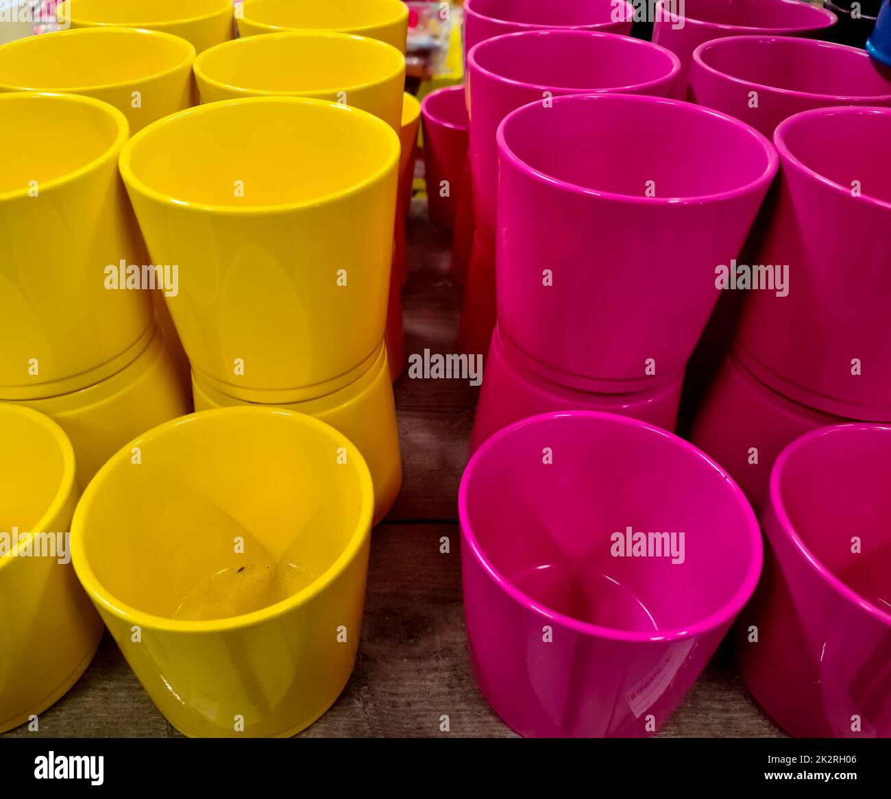 A stack of decorative yellow and pink flower pots. Stock Photo