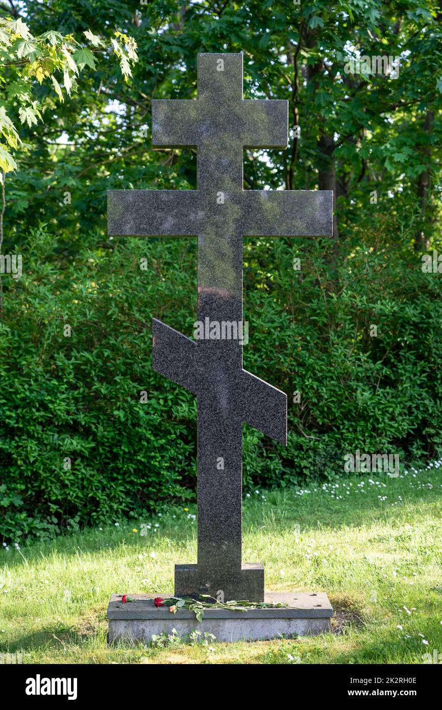Stone Orthodox cross in the cemetery. Stock Photo