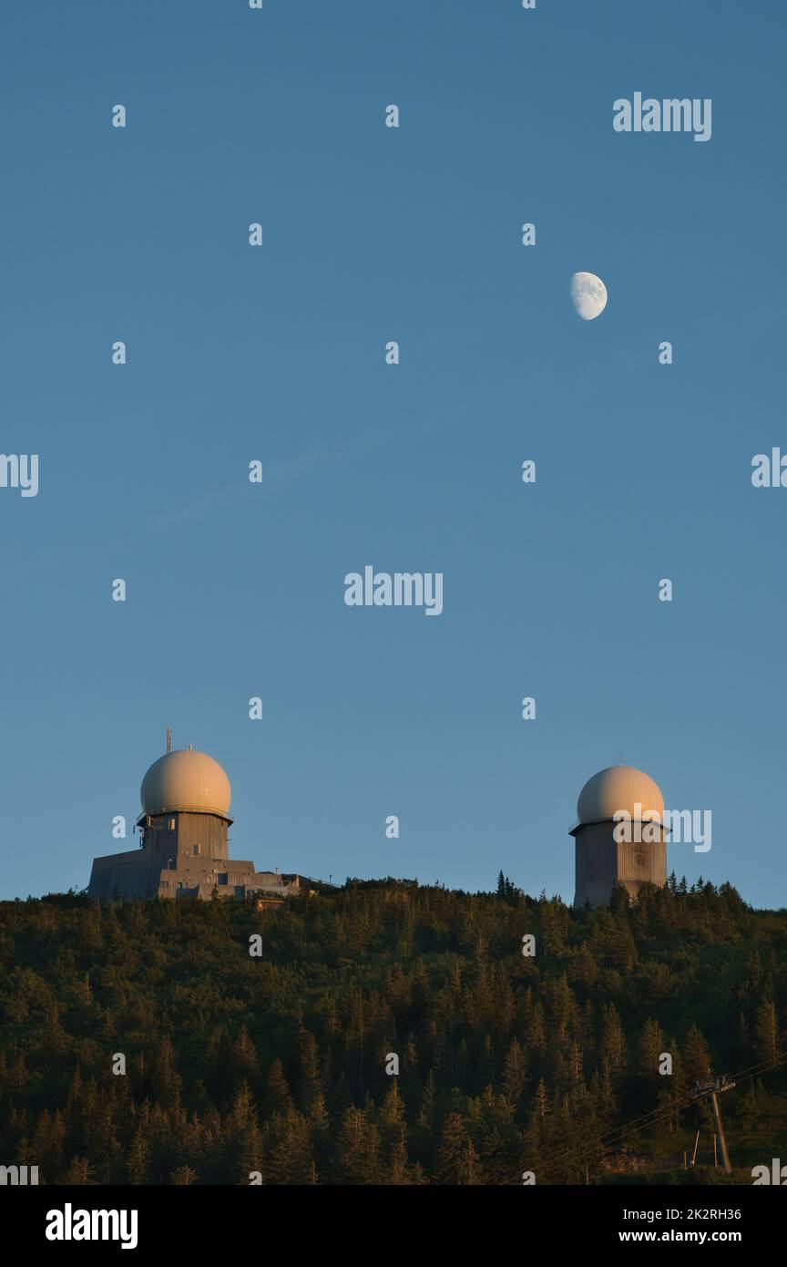 The two towers on mount GroÃŸer Arber at blue hour with the moon above Stock Photo