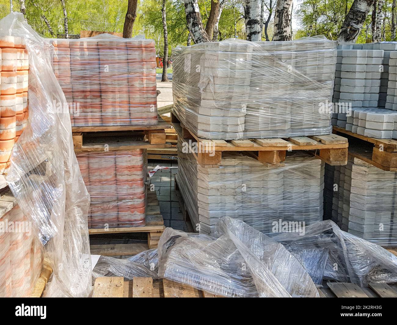 Close-up, the new paving slabs are neatly stacked on pallets. Repair of sidewalks and replacement of paving slabs. Reconstruction of urban infrastructure Stock Photo
