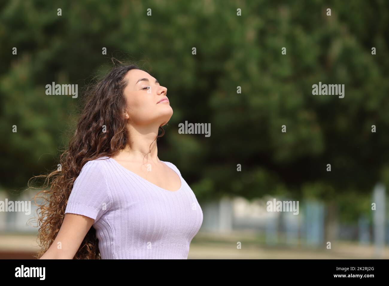 Relaxed woman breathing fresh air in a park Stock Photo - Alamy