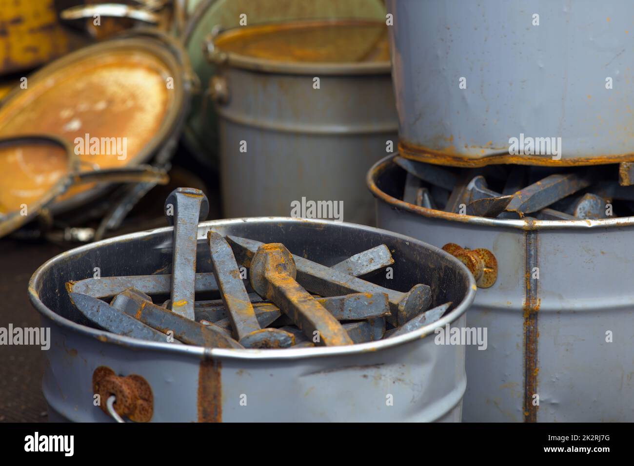 large nails for railroad track fix metal objects paint cans rust steel objects Stock Photo