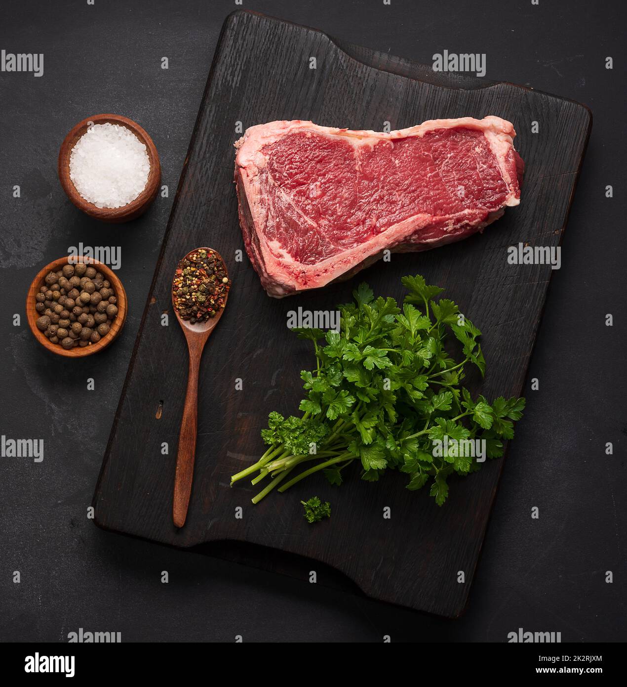 Fresh raw piece of beef meat, striploin steak on a black background
