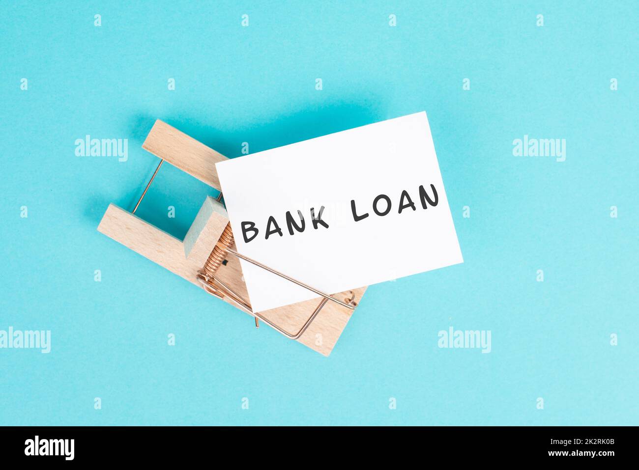 Paper with the words bank loan in a mousetrap, finanicial debt, inflation, risky credit and investment Stock Photo
