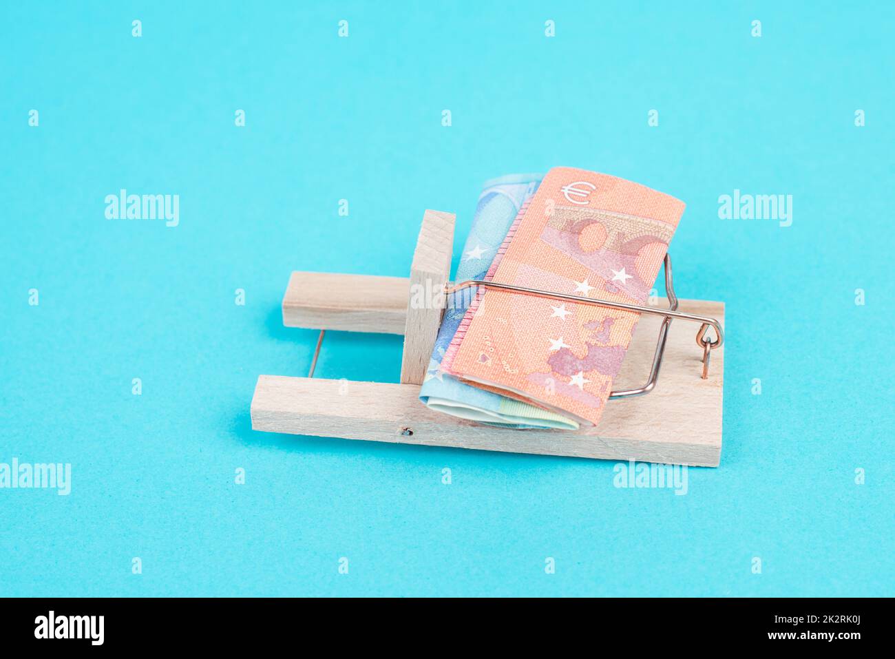Euro banknotes in a mousetrap, bank loan, finanicial debt, inflation, risky credit and investment Stock Photo
