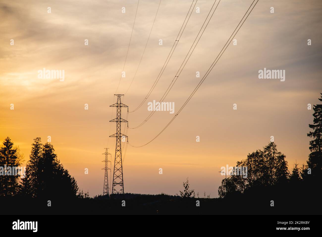 A silhouette of electric transmission tower against sunset sky Stock ...