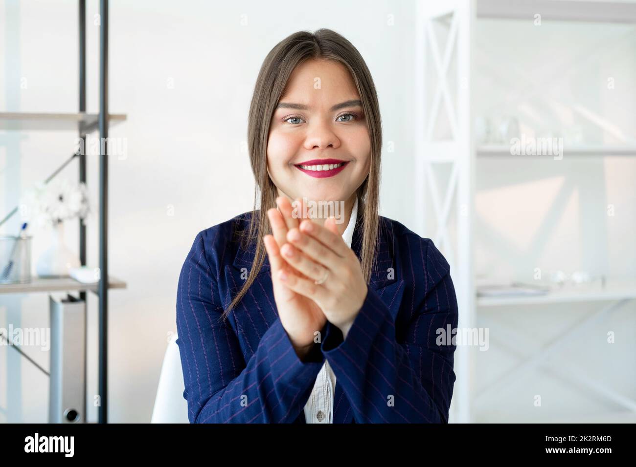 Successful career. Corporate congratulation. Professional growth. Goal achievement. Cheerful satisfied smart business woman smiling applauding in ligh Stock Photo