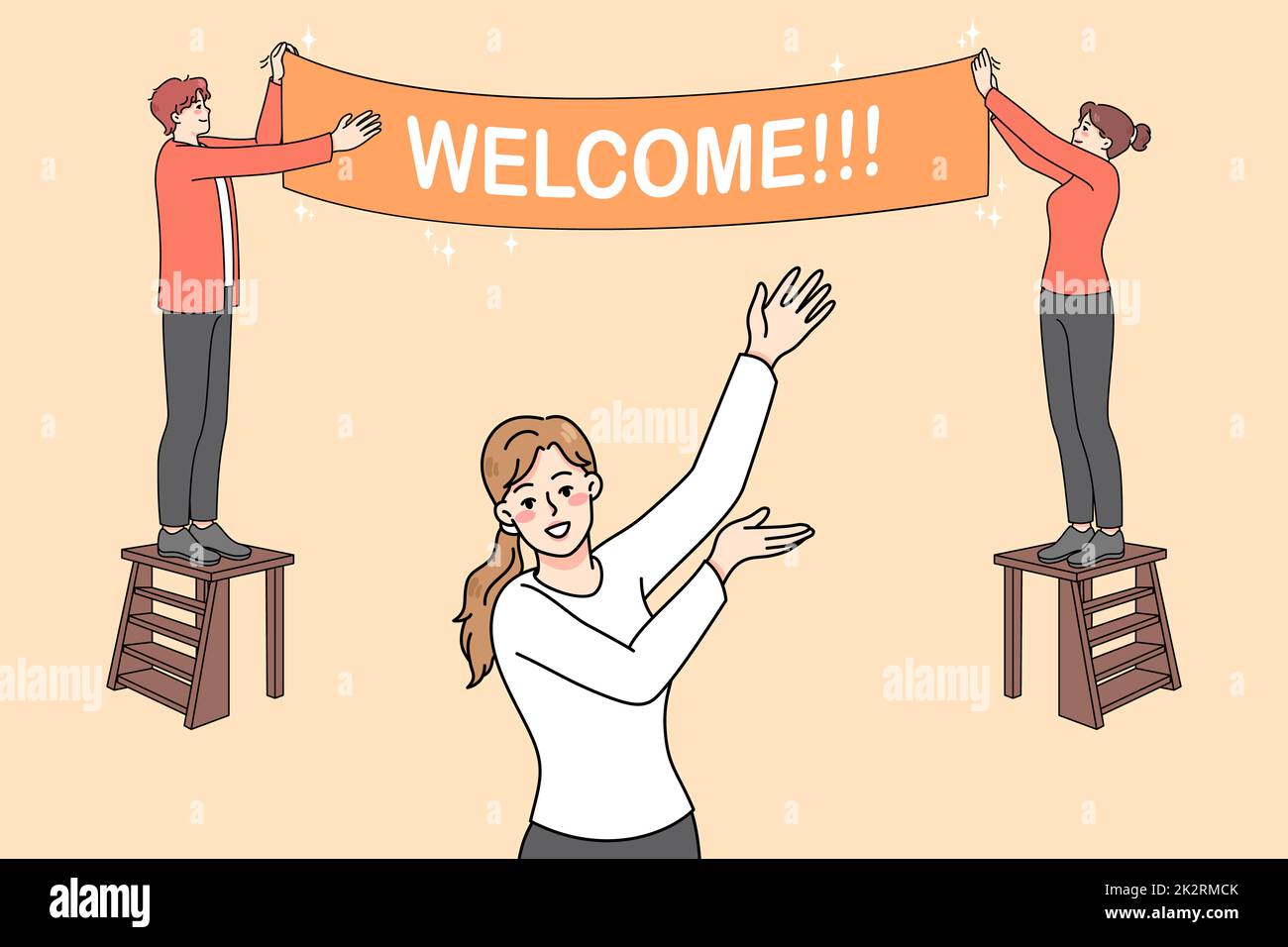 Happy people hanging welcome banner Stock Photo