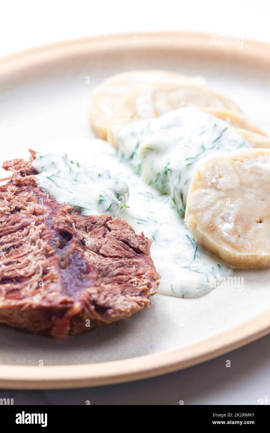 beef meat with dill sauce and dumplings Stock Photo Alamy