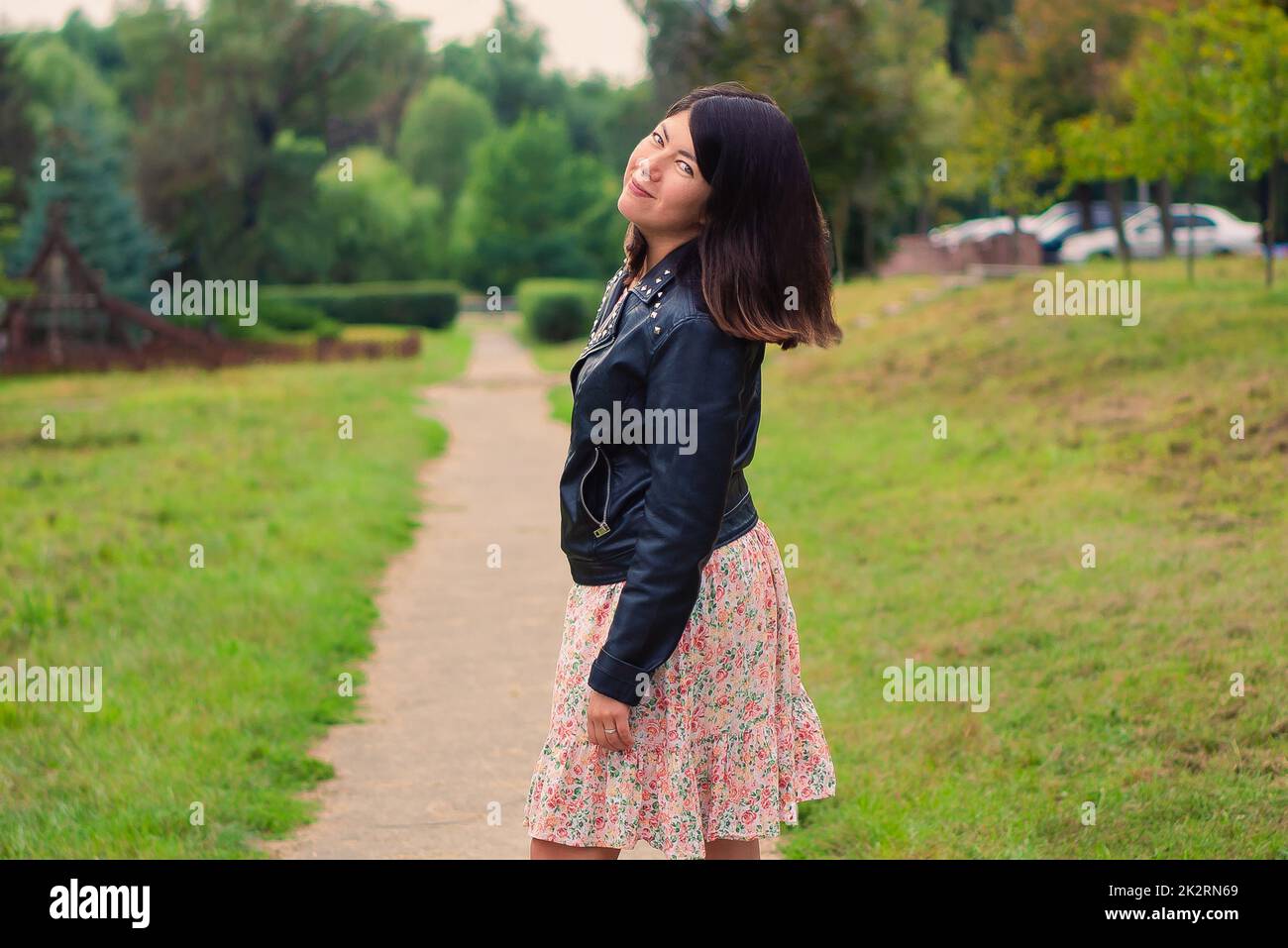 young pretty brunette woman with beautiful long hair in the park Stock ...