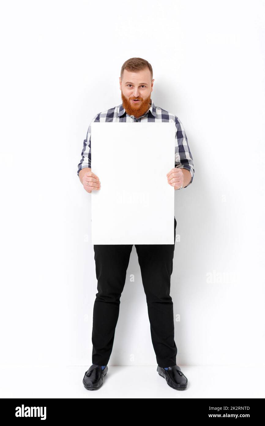 man with beard holding big white card Stock Photo Alamy