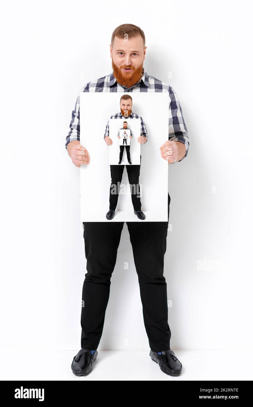 Man with beard holding big white card stock photo alamy
