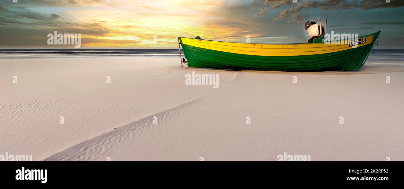 Sunrise over Baltic Sea with empty fishing boat - Debki, Pomerania, Poland Stock Photo