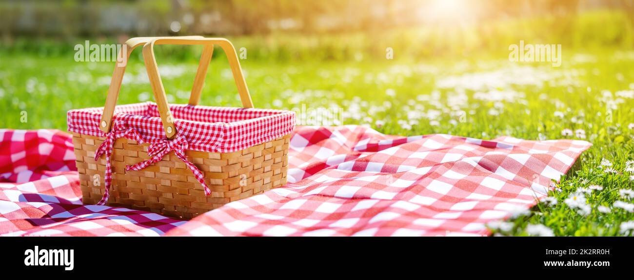 Picnic duvet with empty bascket on the meadow in nature. Stock Photo