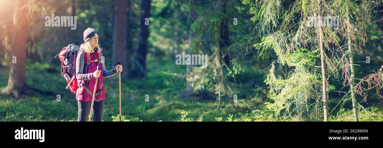 Young woman hiking and going camping in nature. Panoramic view.Concept of tourism. Stock Photo