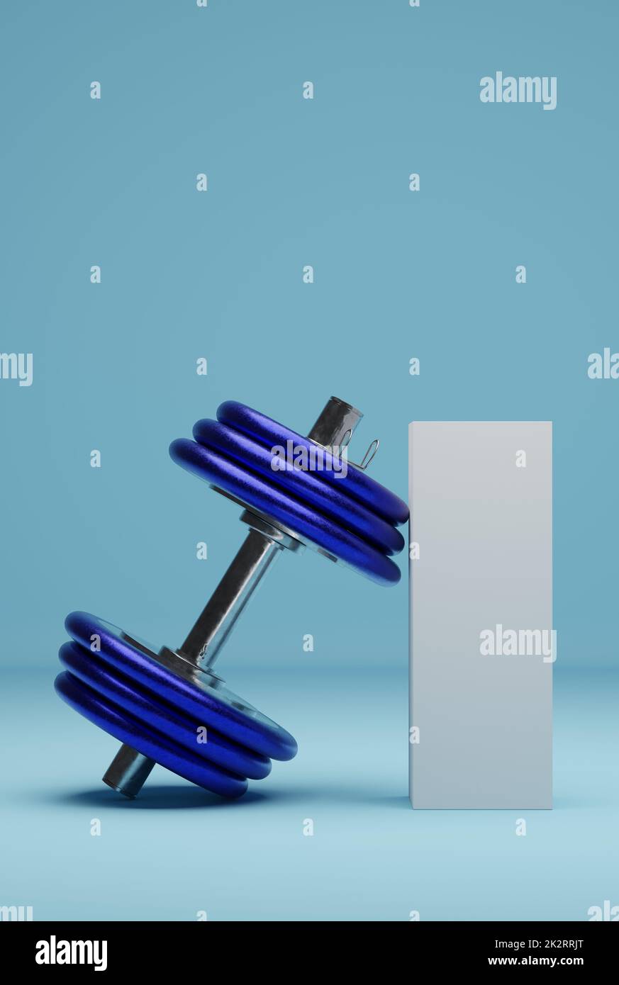 A blue dumbbell leaning against an unlabeled white package Stock Photo