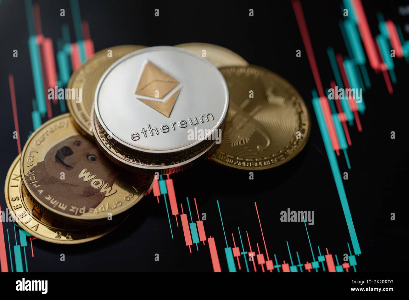 Stack or heap of gold various cryptocurrency with candle stick graph chart and digital background. Stock Photo