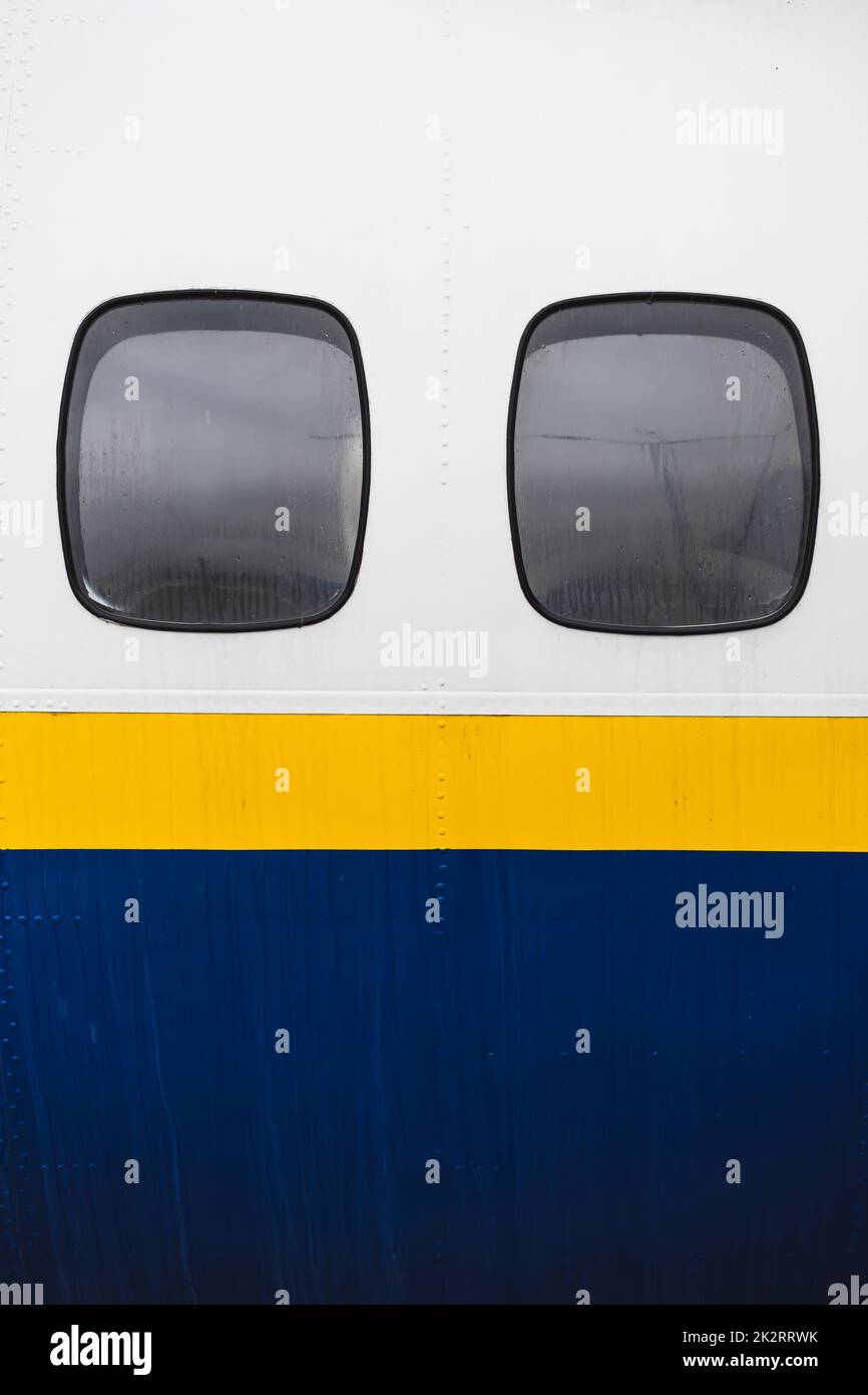 Airplane windows from the outside, at the airport. Stock Photo