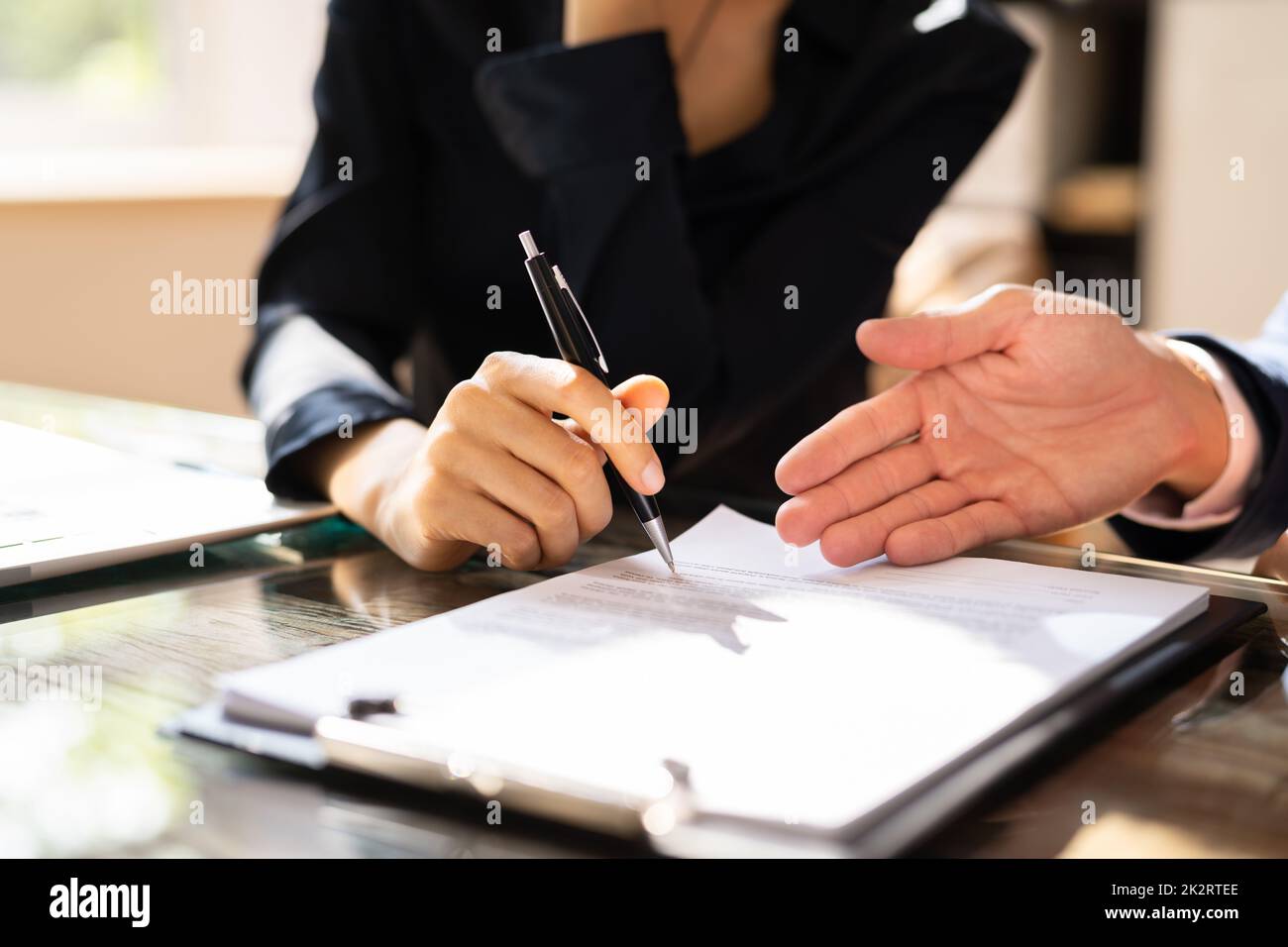 Two Businesspeople Analyzing Document Stock Photo