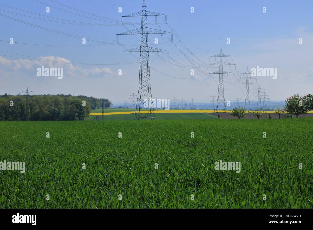 Several high voltage pylons against a blue sky Stock Photo