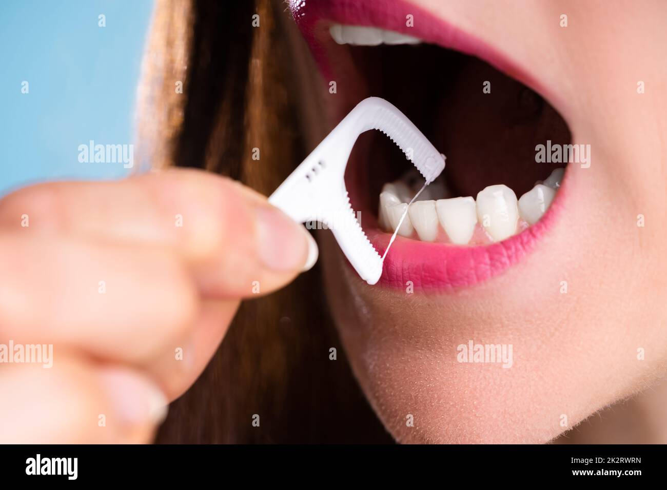 Woman Cleaning Teeth With Dental Floss Stock Photo Alamy