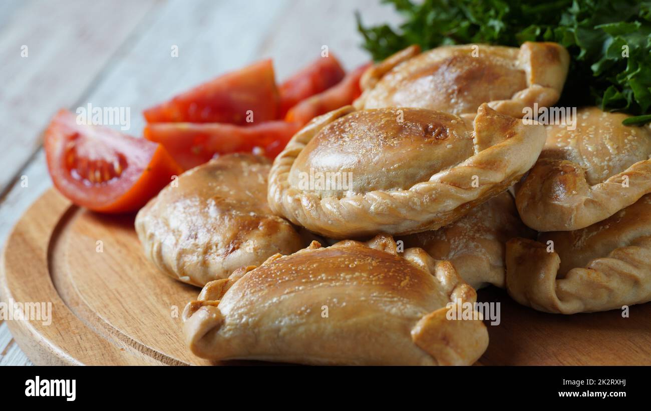 Latin American fried empanadas with tomato sauce. Argentinian Empanada is a pastry turnover