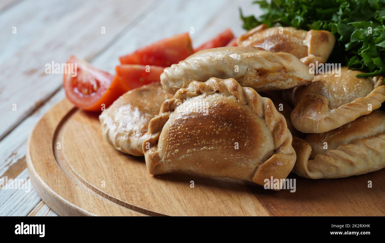 Latin American fried empanadas with tomato sauce. Argentinian Empanada