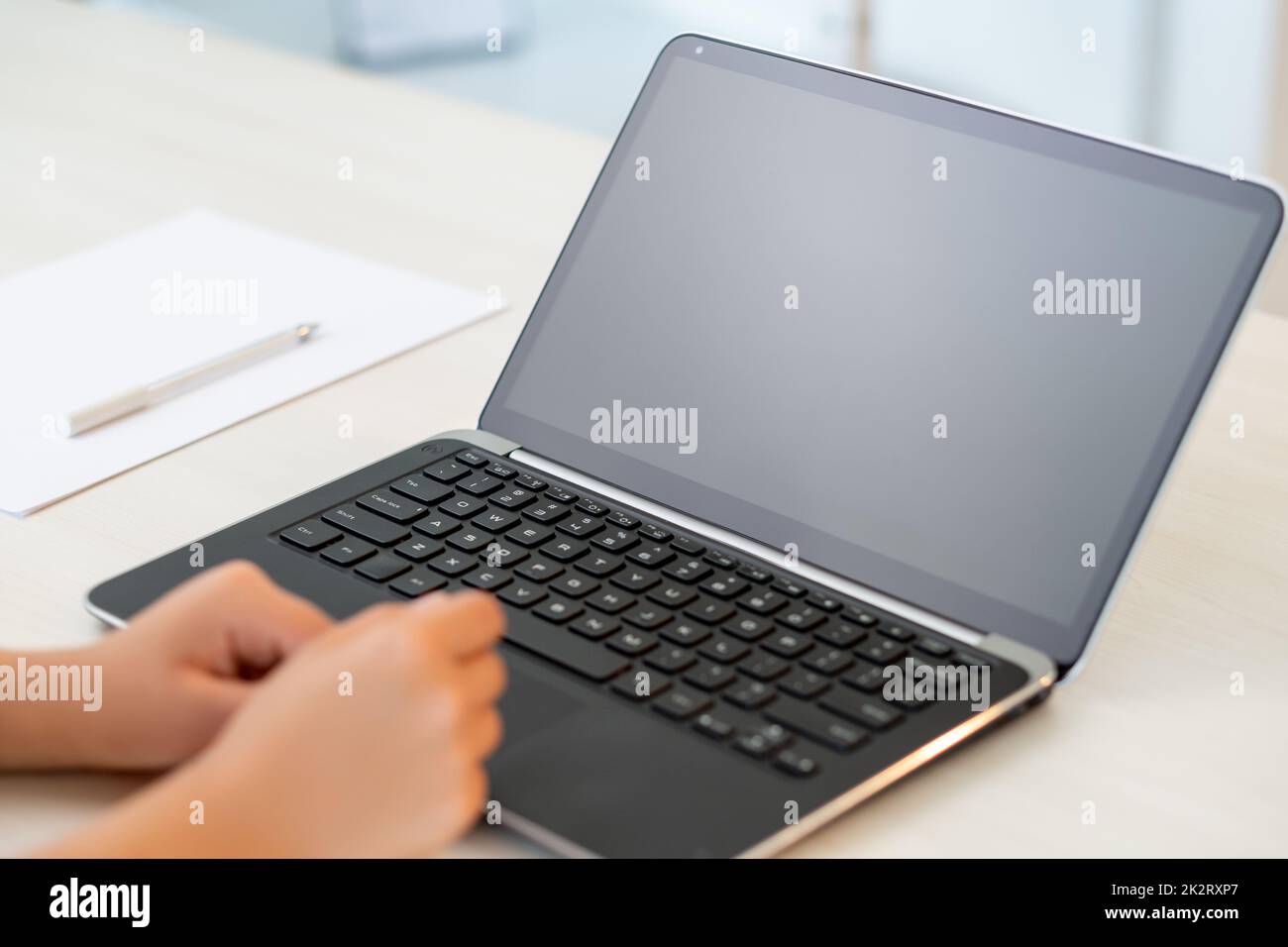 Online business. Freelance work. Remote job. Distance communication. Female hands laptop with empty screen on home office light workplace. Stock Photo