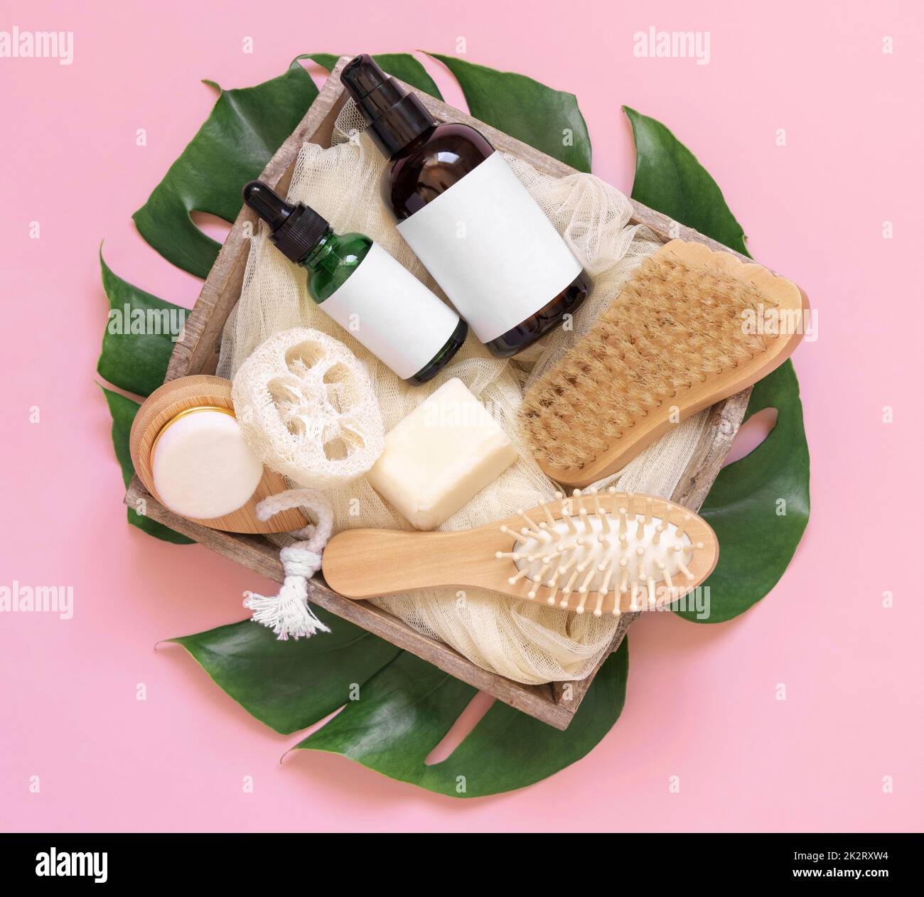 Tray of Cosmetics, skin and hair care accessories on tropical leaves on