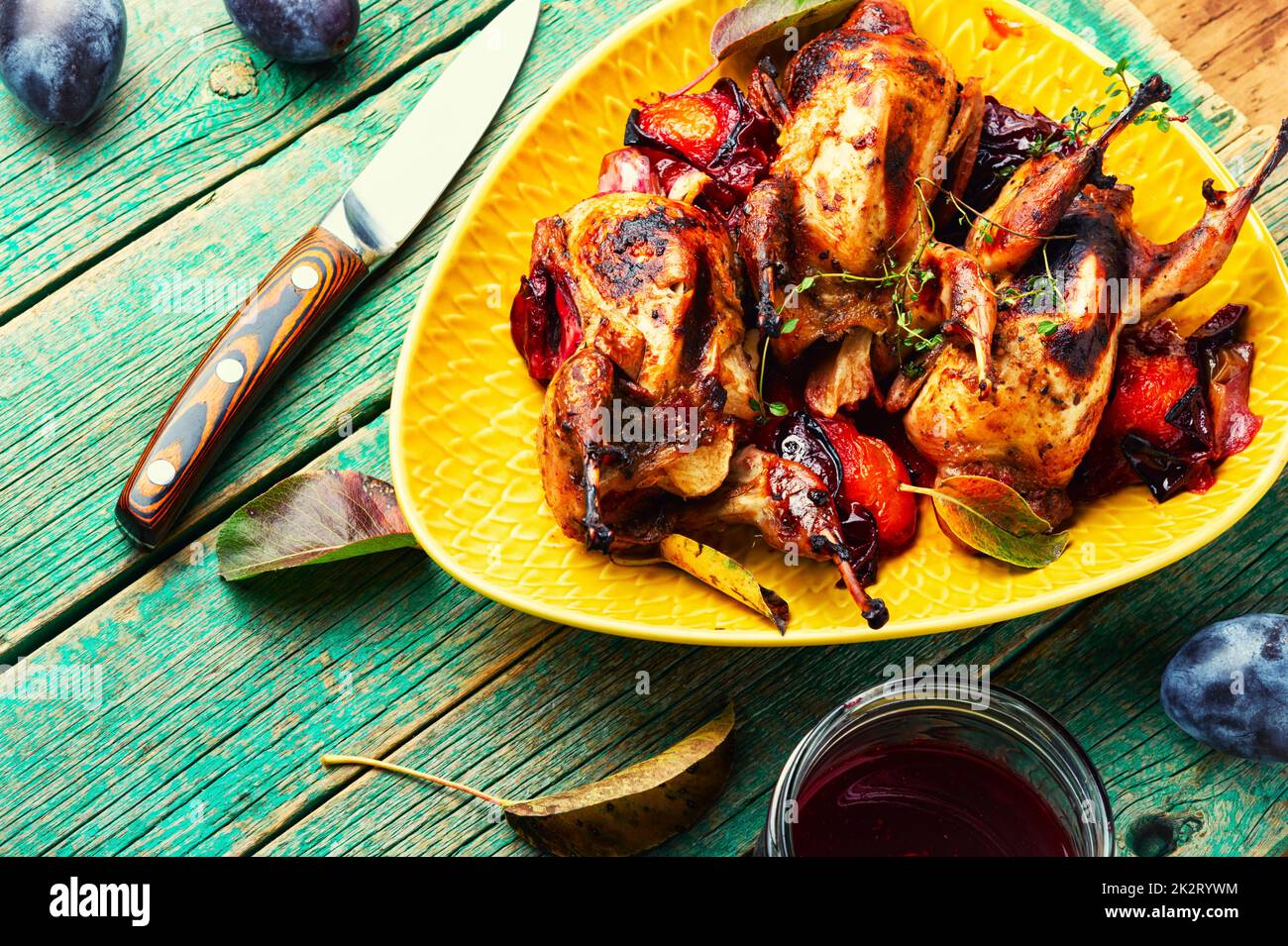 Quail stuffed with plums. Stock Photo
