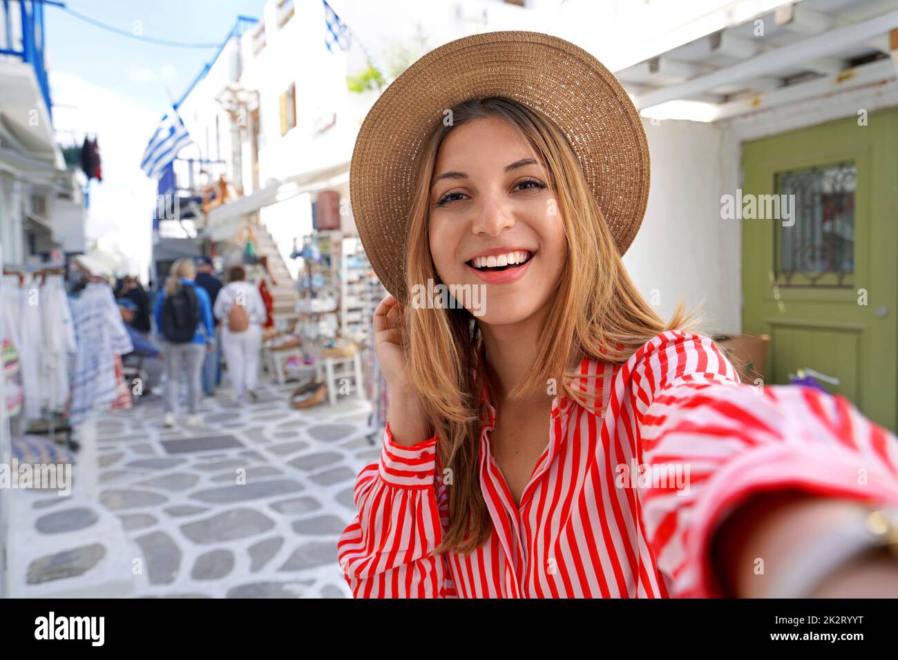 Self portrait of young woman with white smile strolling in Mykonos, Greece Stock Photo