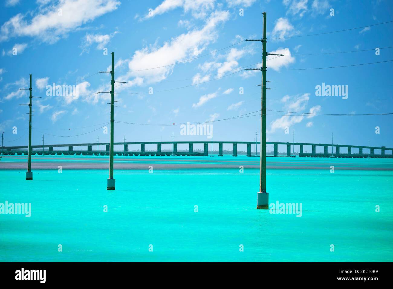 Power lines over turquoise sea in Florida Keys Stock Photo