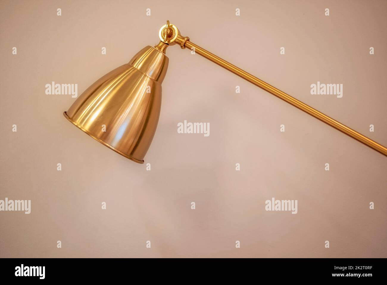 Golden desk lamp light modern copper background Stock Photo