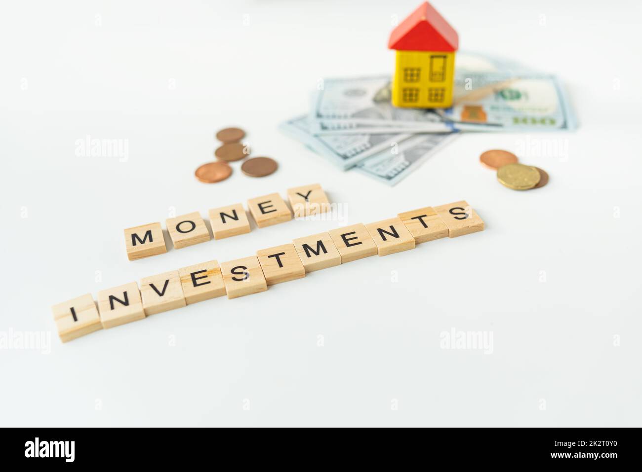 International currency money including euro, dollar, coin, dollar bill. The inscription in wooden letters money investments. The concept of mortgages, investments, loans, debts. Stock Photo