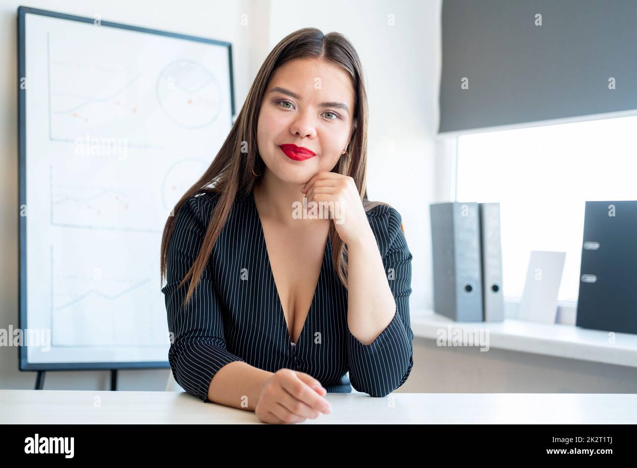 Female leadership. Project management. Strategy planning. Professional career. Confident ambitious smart woman at light office with graphs charts on w Stock Photo