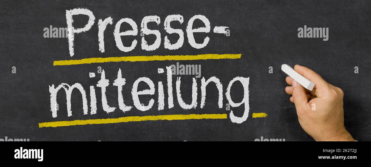 Text written on a blackboard - Press release in german - Pressemitteilung Stock Photo