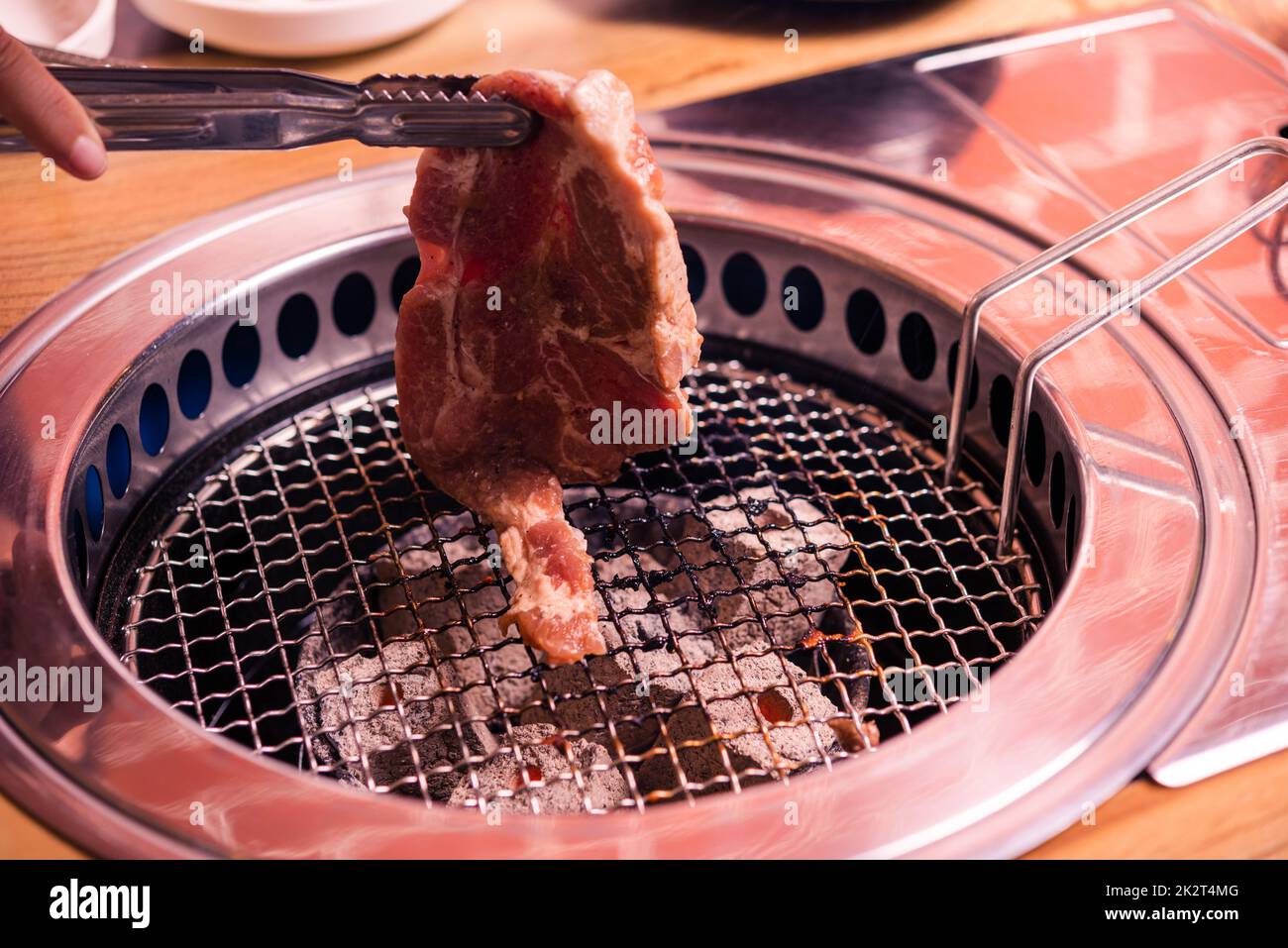 Grilling meat pork Korean BBQ traditional style on stove serve in restaurant Stock Photo