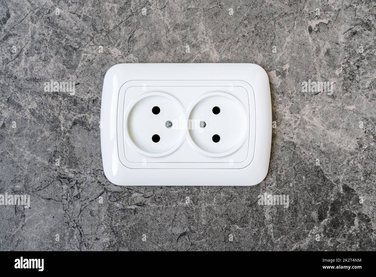 European electric outlet on tiled wall Stock Photo Alamy