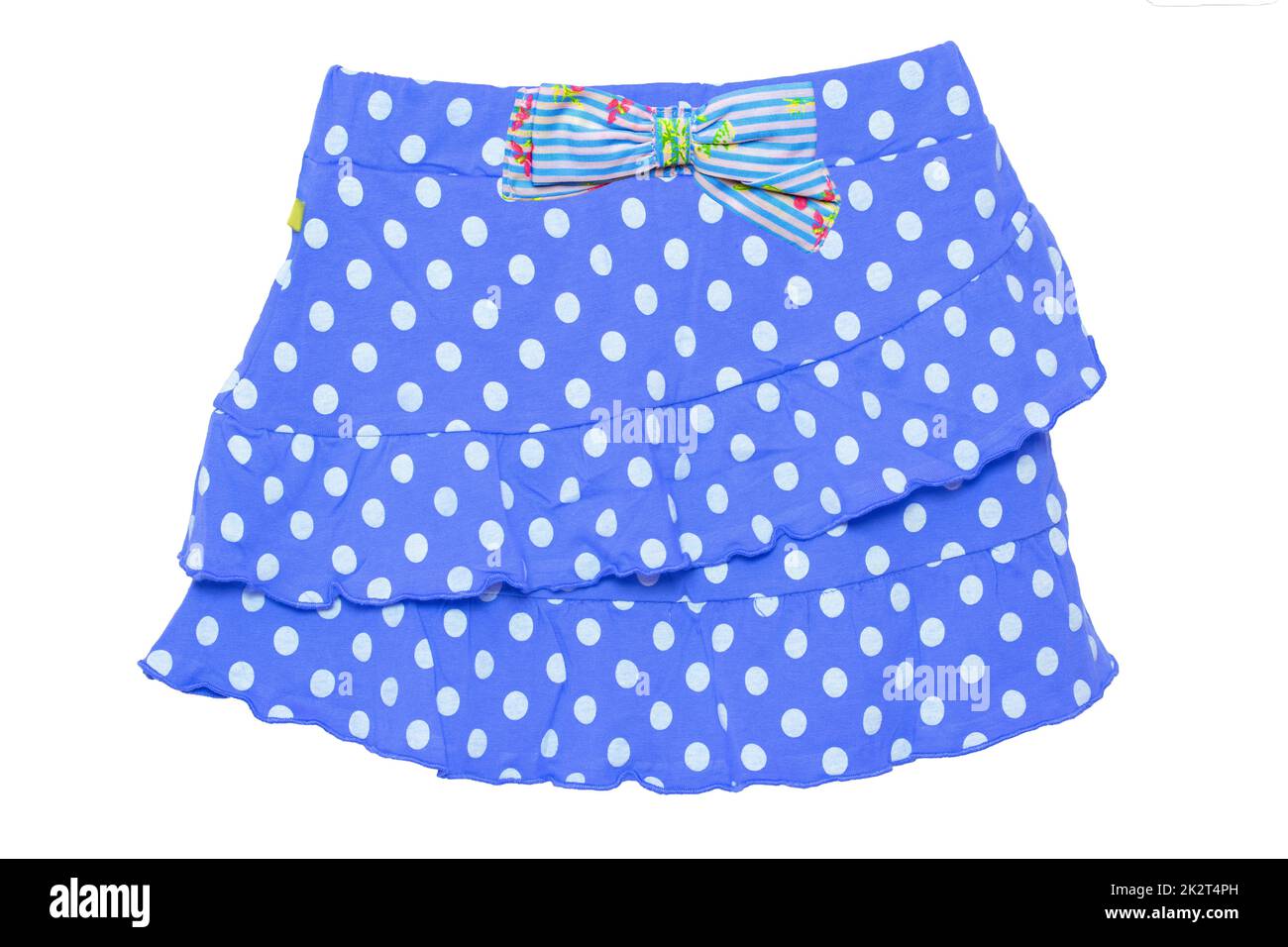 Summer skirt isolated. Closeup of a beautiful blue little girl short polka dot skirt with a colorful bow isolated on a white background. Children and kids fashion. Macro. Stock Photo