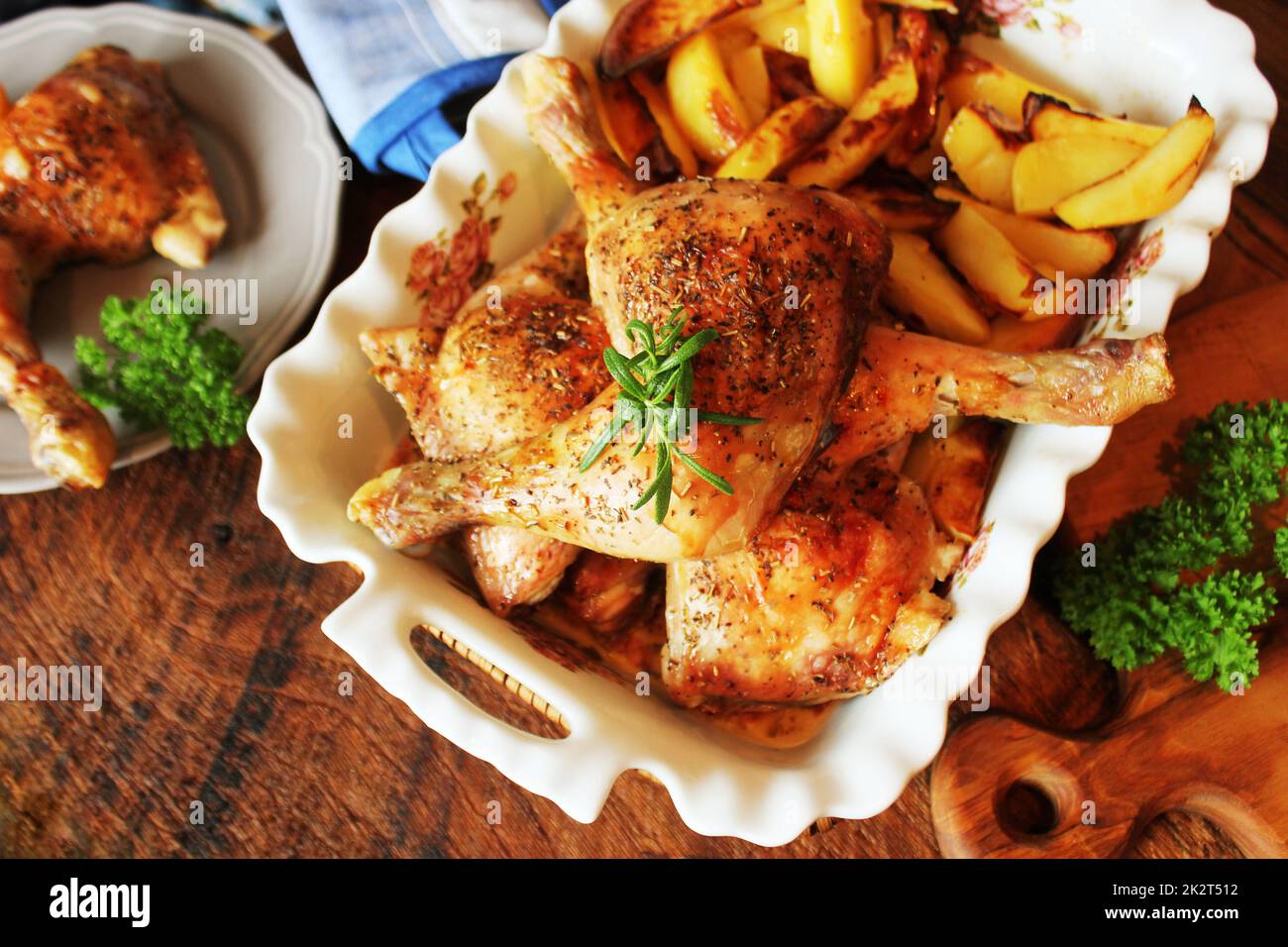 Grilled chicken leg with potato for garnish. Top view. Wooden ...