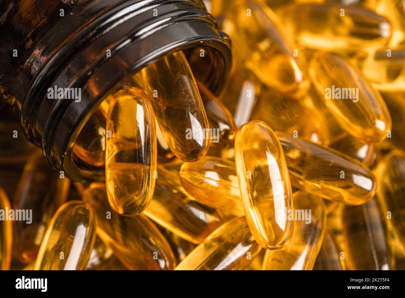 Fish oil Omega 3 capsules vitamin with EPA and DHA isolated on wooden background. Stock Photo