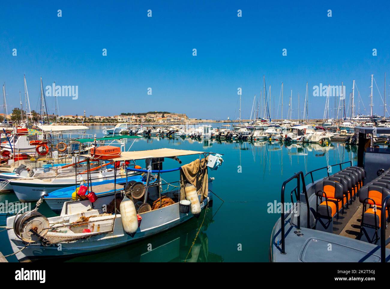 Boats moored in the old harbour at Rethymno or Rethymnon a resort town on the coast of northern Crete in Greece. Stock Photo
