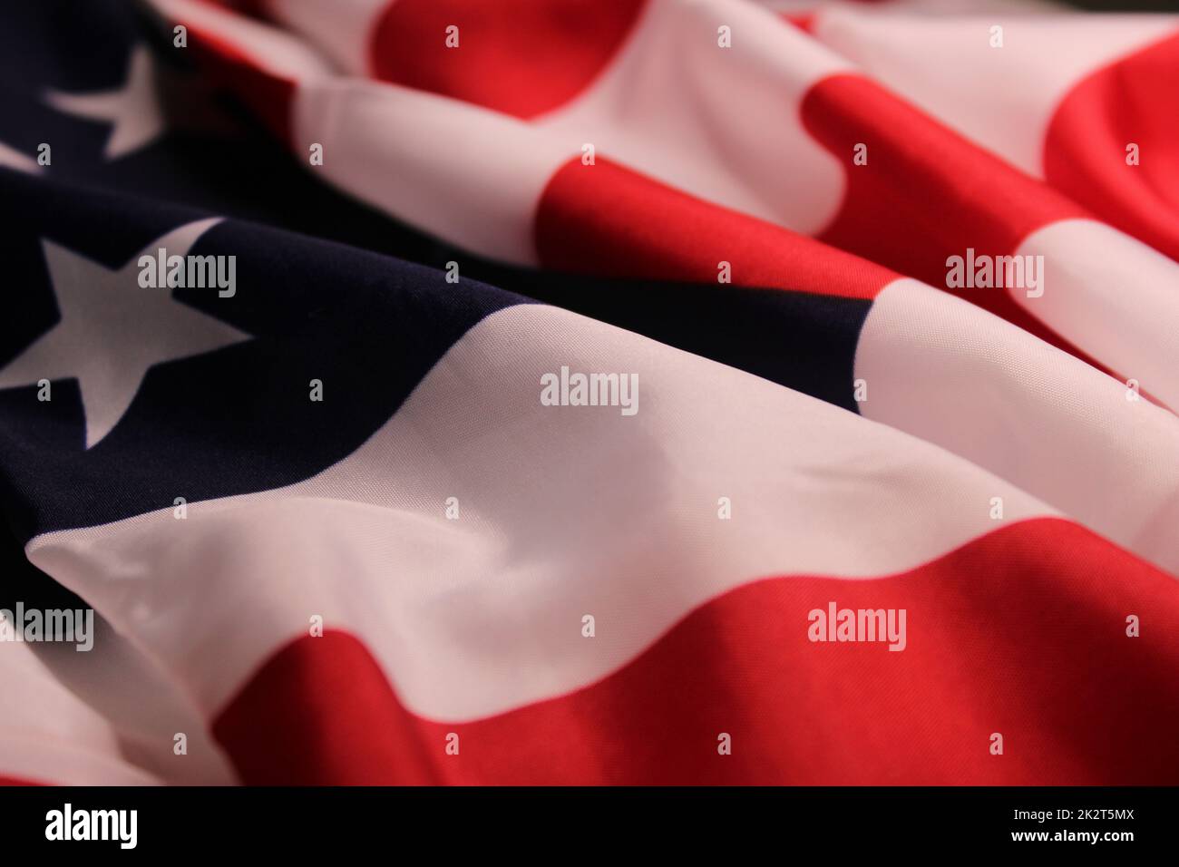 The flag of the United States, folded in waves. The concept of Independence Day, elections, Memorial Day. Stock Photo