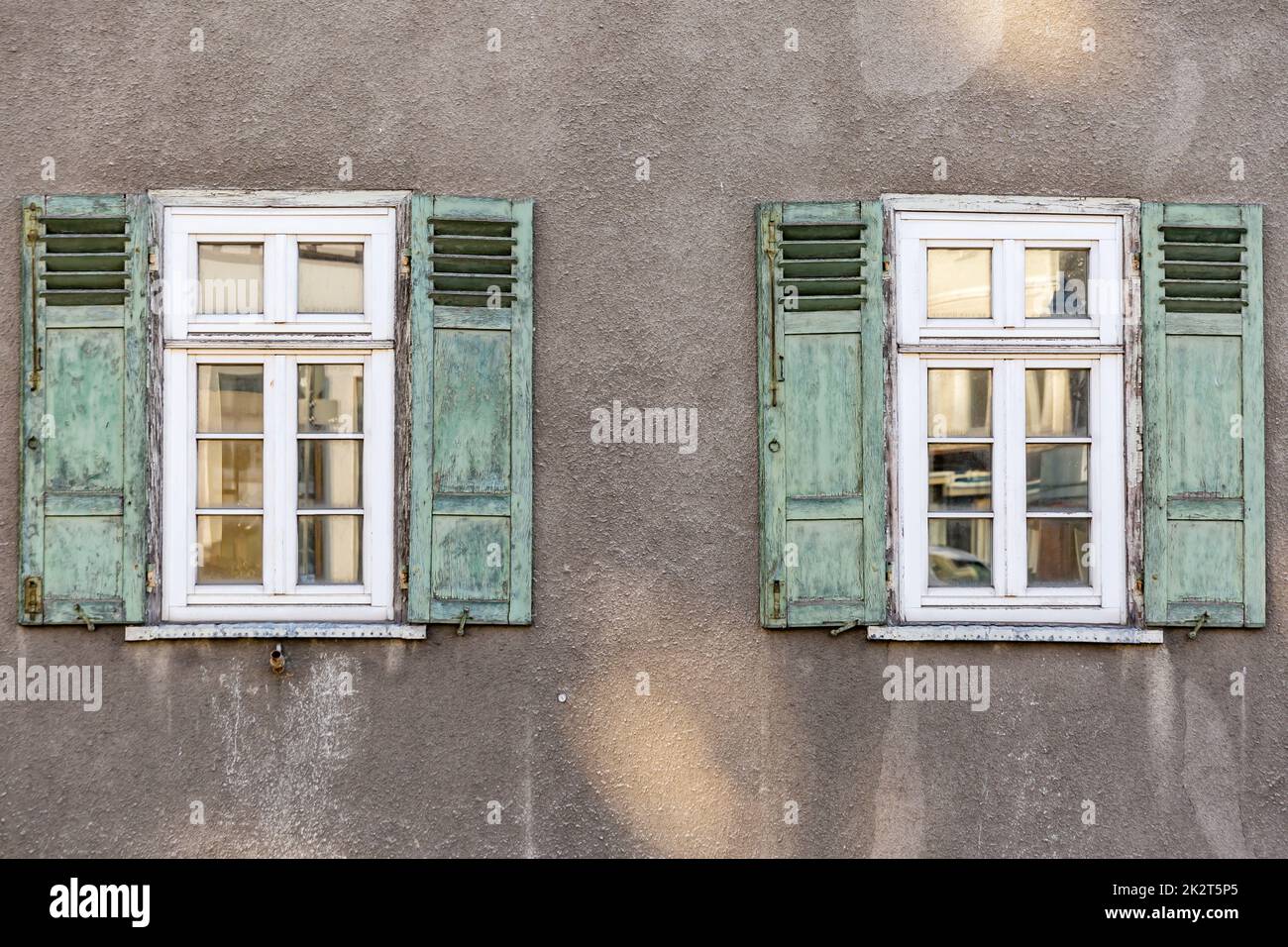 Old House Facade with green wooden folding shutters in detail Stock Photo