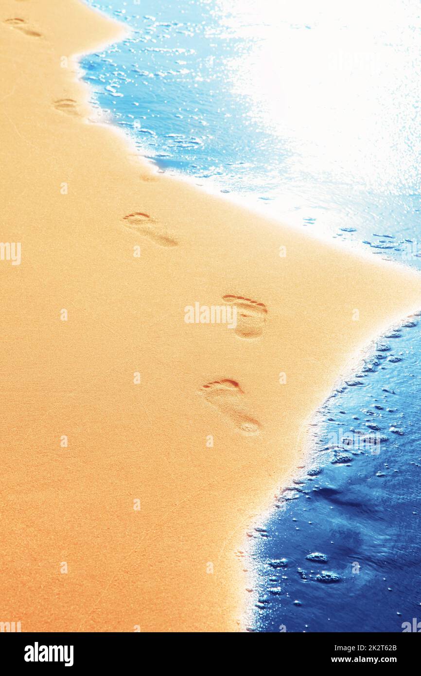 Walking on the beach, leaving footprints in the sand Stock Photo - Alamy