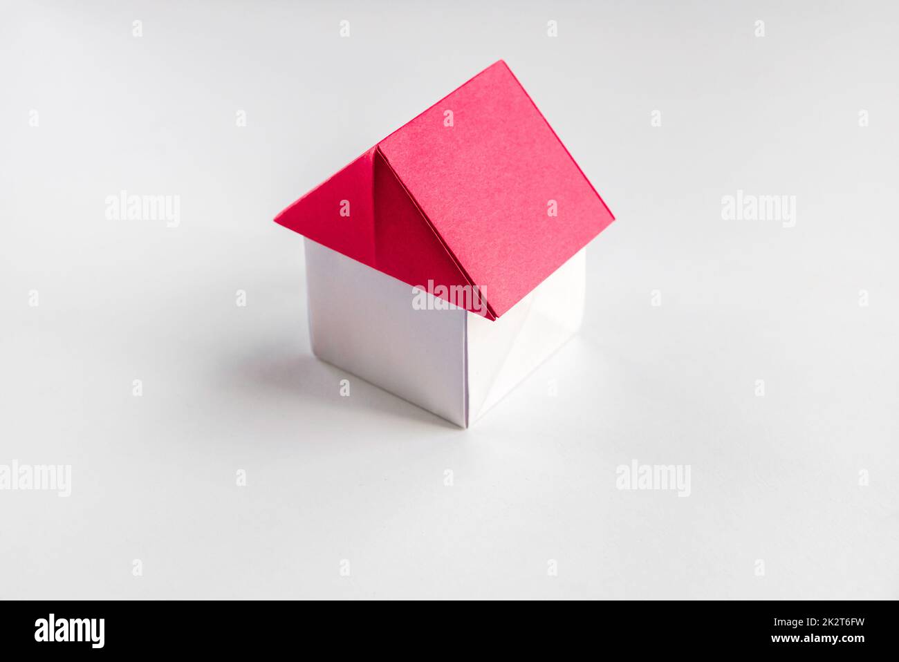 White and red paper house origami isolated on blank background Stock Photo