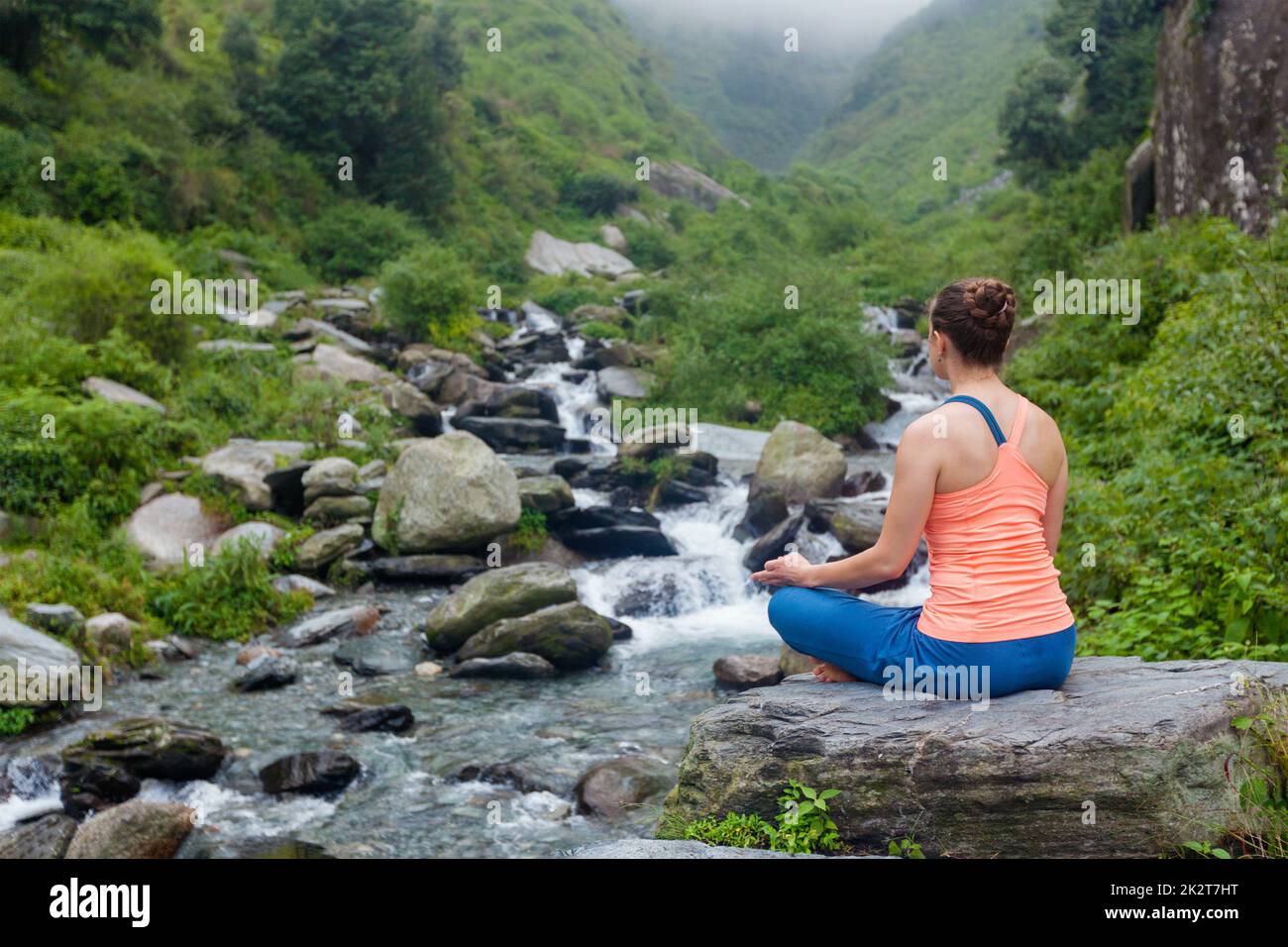 Woman doing yoga outdoors Stock Photo